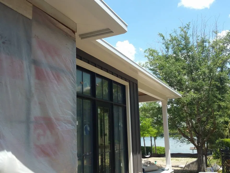 White fascia gutter covered porch column lakefront new construction, Sanford